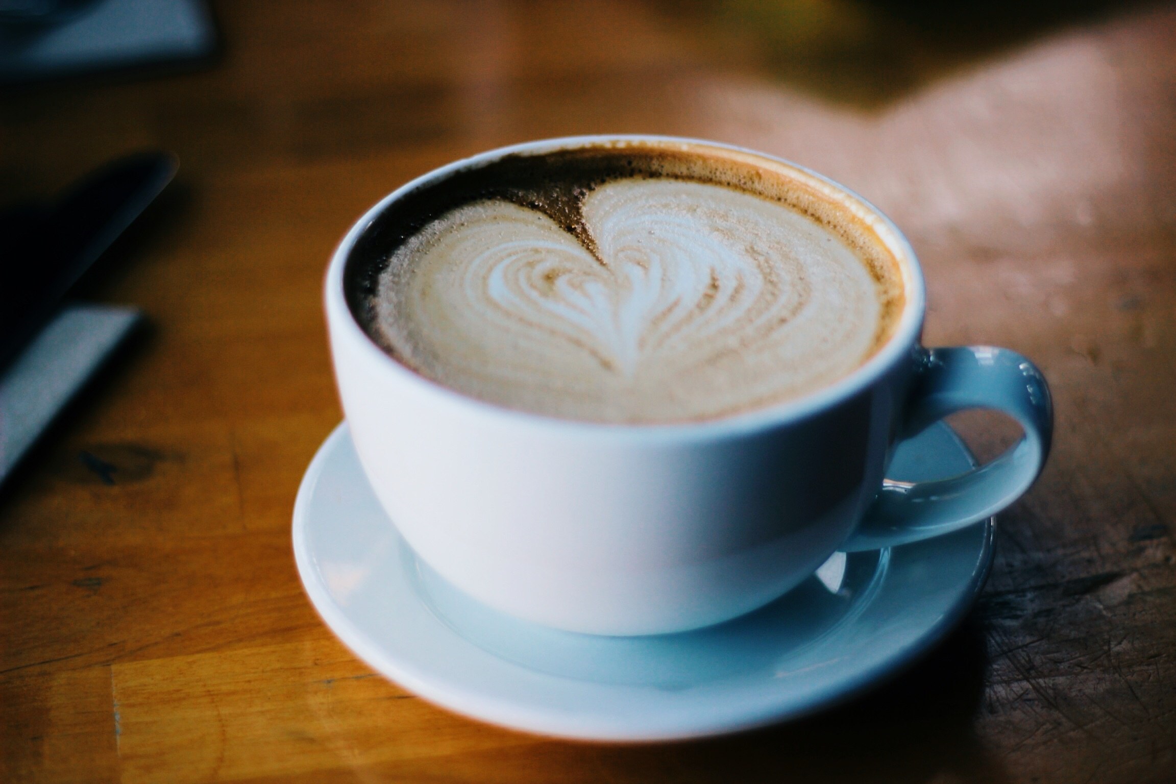 latte coffee with heart-shaped cream swirl